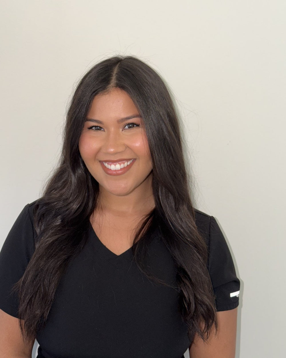 Xiara Perez, BSN, RN, smiling in scrubs